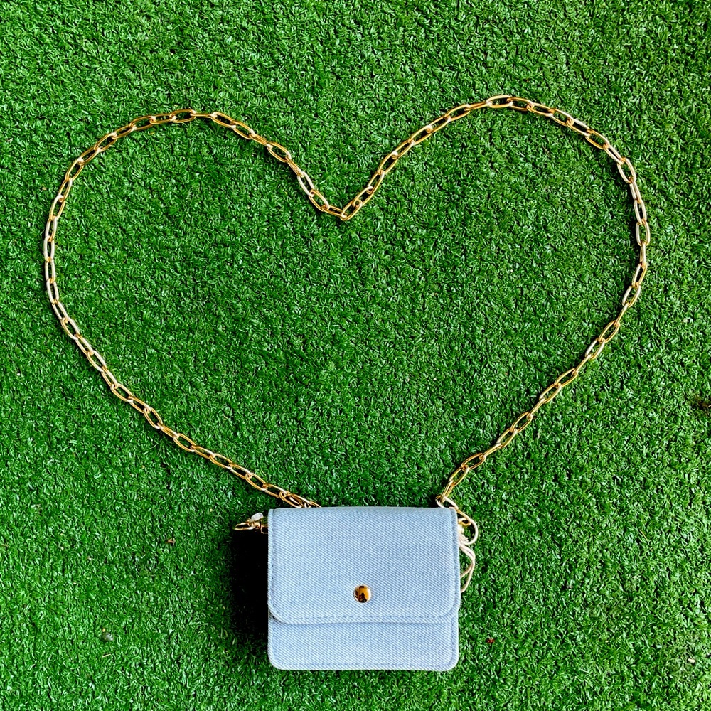 Blue and white crossbody bag with detachable gold chain.